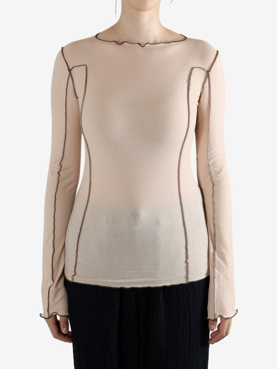 Tan shirt worn by a person, showing the shirt's fit