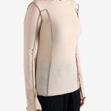 Tan shirt worn by a person, showing the shirt's fit