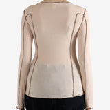 Tan shirt worn by a person, showing the shirt's fit