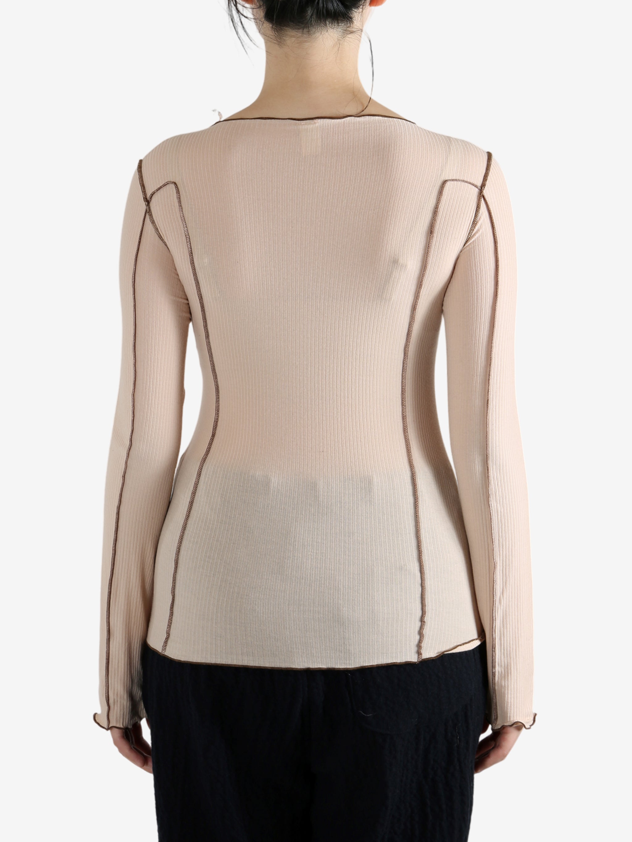 Tan shirt worn by a person, showing the shirt's fit