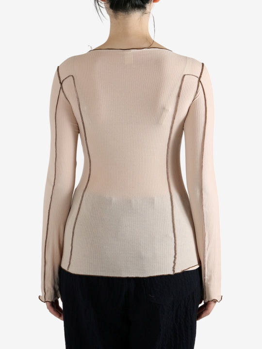 Tan shirt worn by a person, showing the shirt's fit