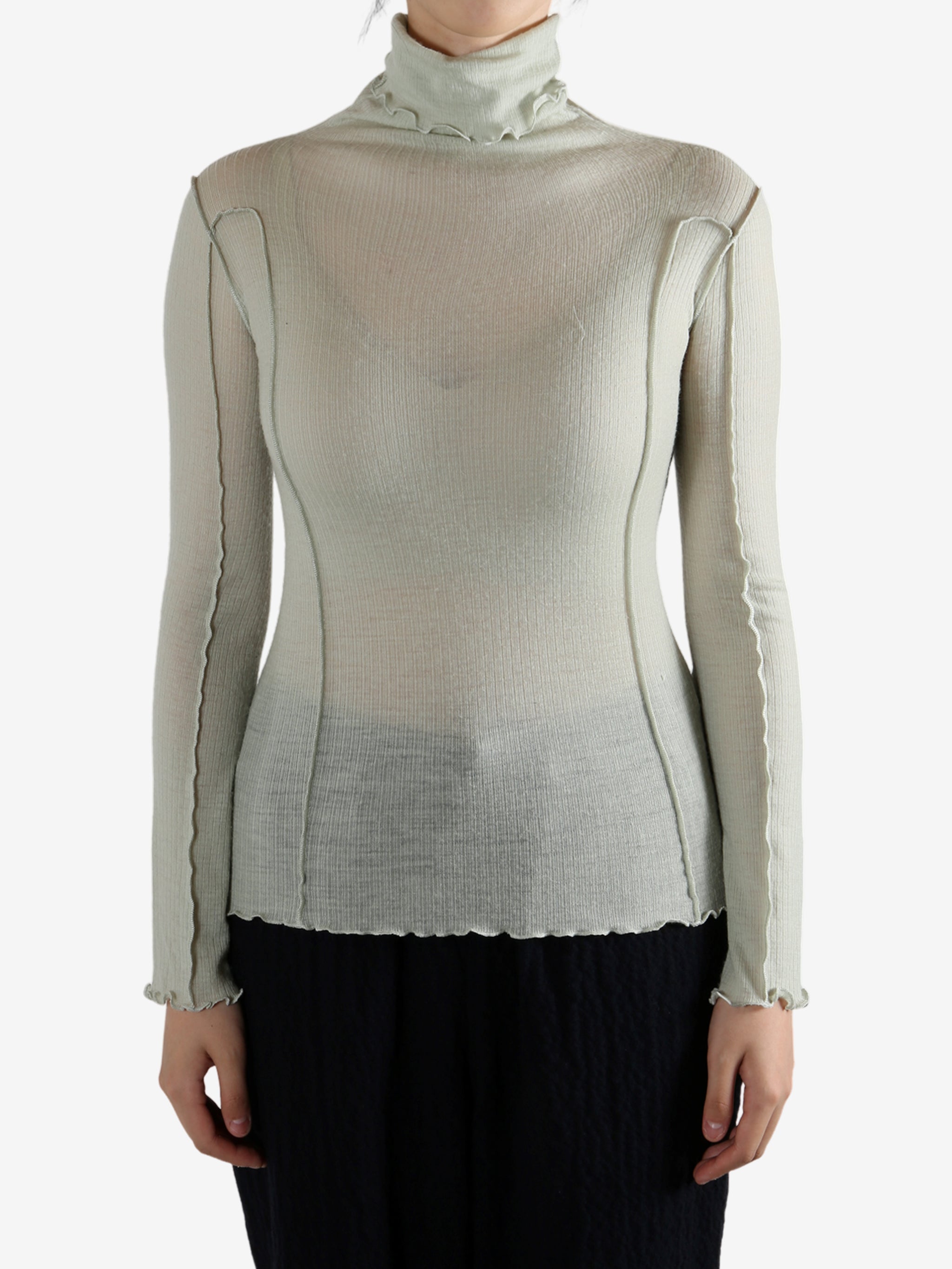 Green shirt worn by a person, showing the shirt's fit