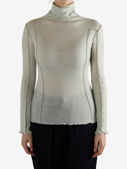 Green shirt worn by a person, showing the shirt's fit