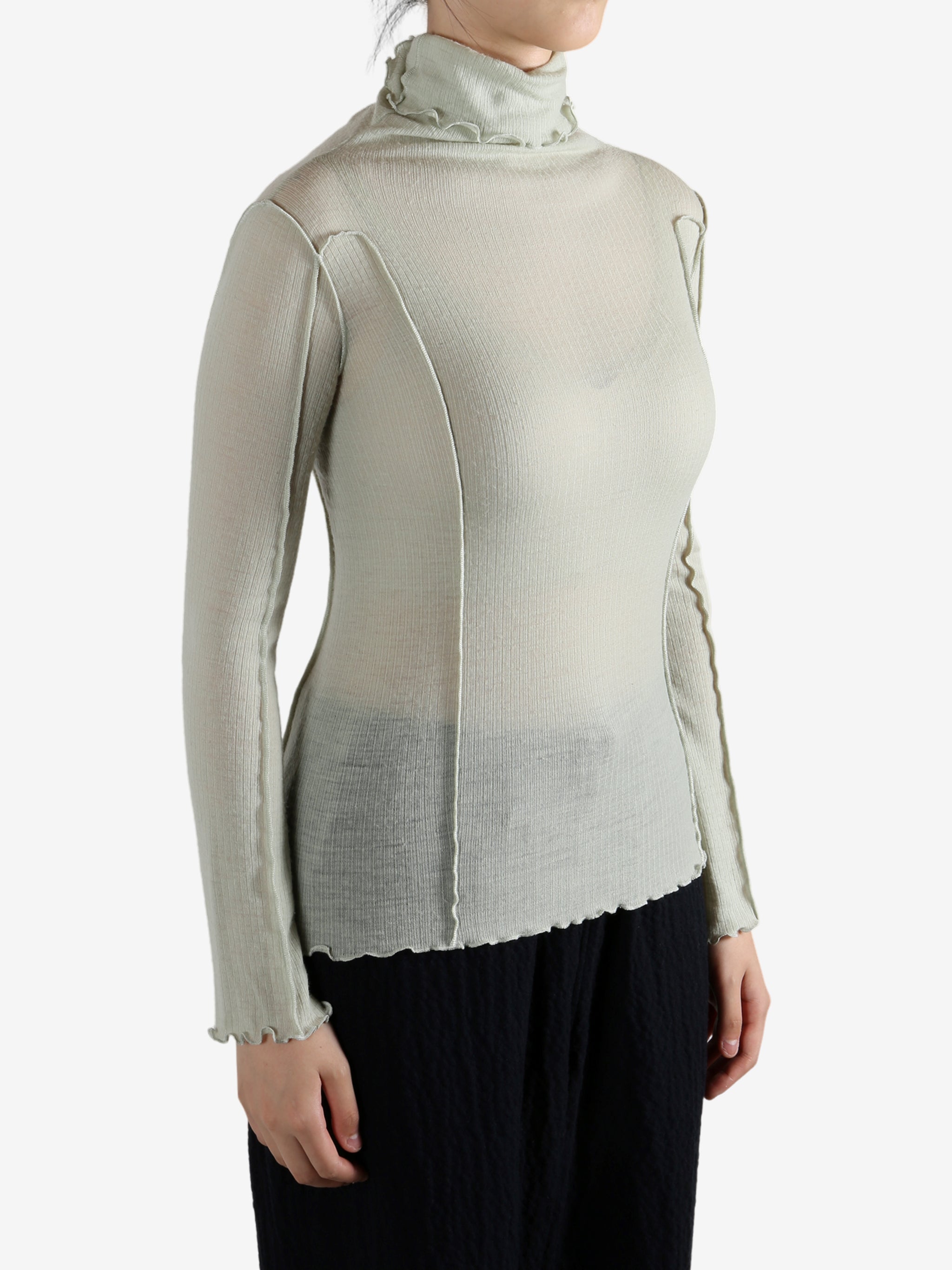 Green shirt worn by a person, showing the shirt's fit