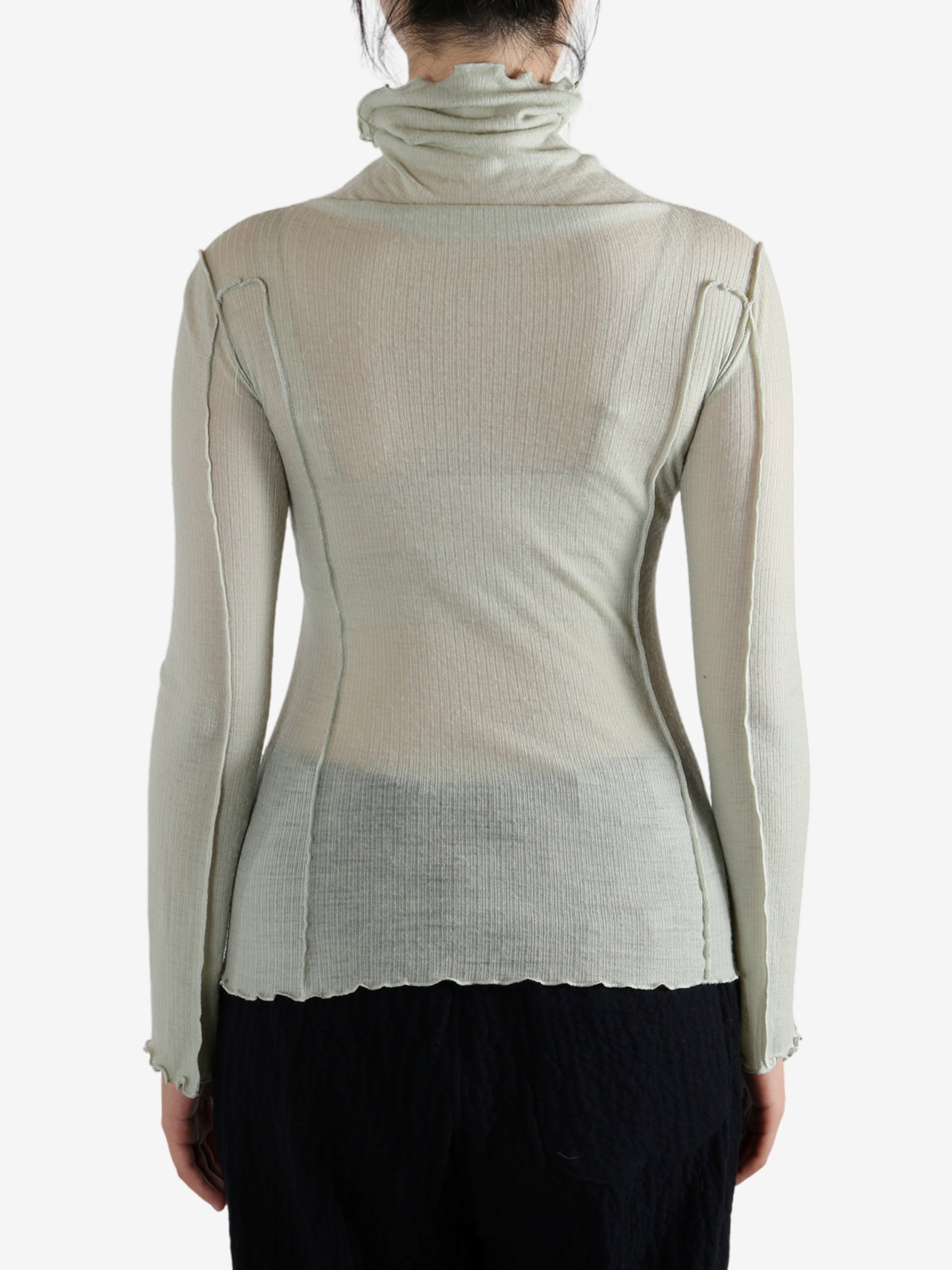 Green shirt worn by a person, showing the shirt's fit