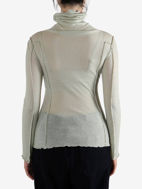 Green shirt worn by a person, showing the shirt's fit