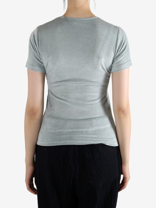 Grey shirt worn by a person, showing the shirt's fit