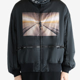 Black coat worn by a person, showing the coat's fit