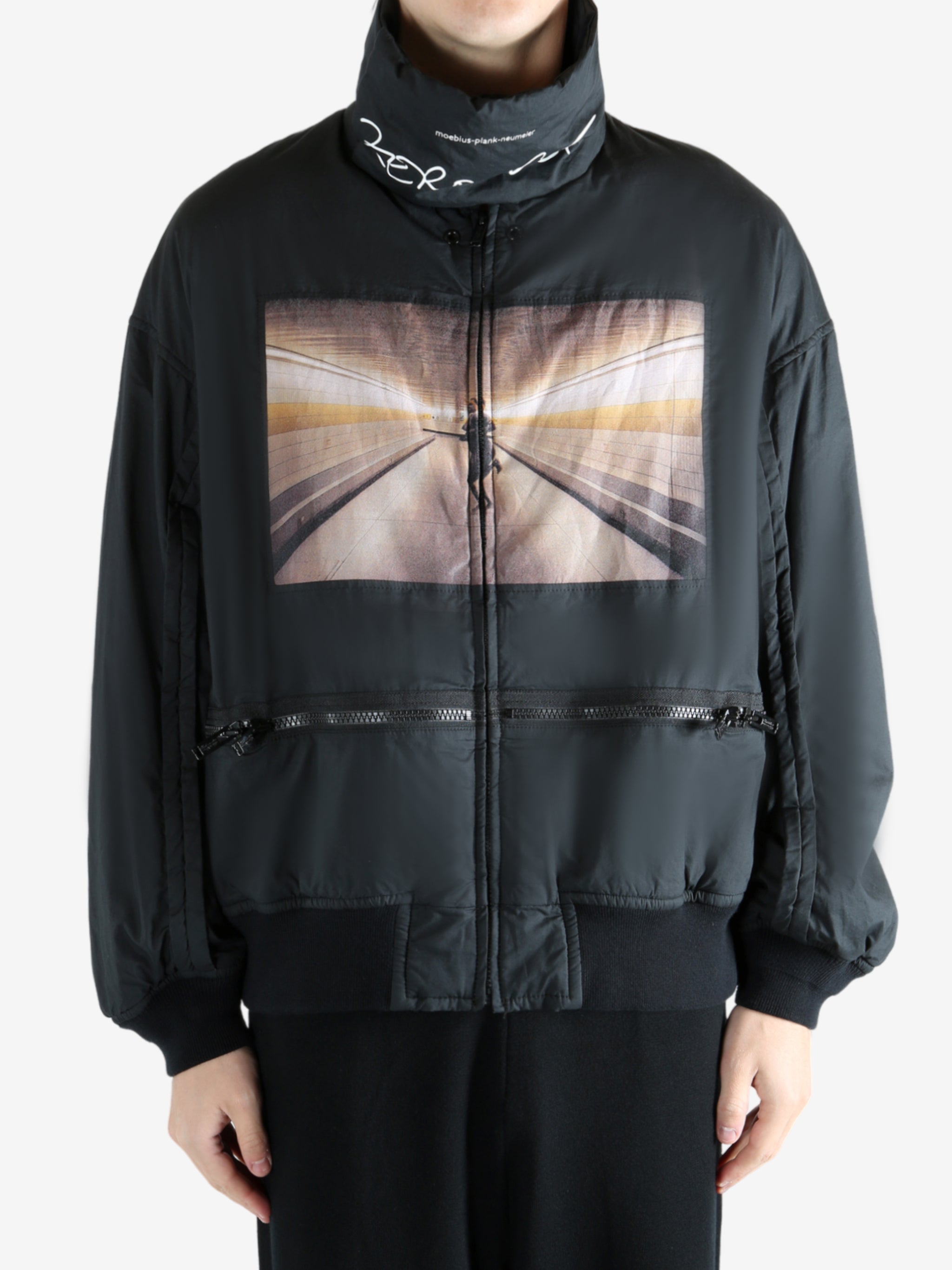 Black coat worn by a person, showing the coat's fit