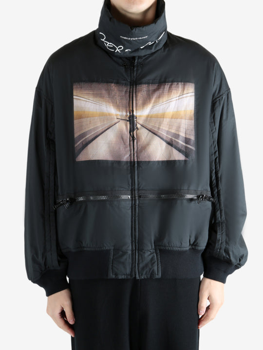 Black coat worn by a person, showing the coat's fit