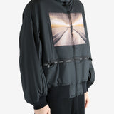 Black coat worn by a person, showing the coat's fit