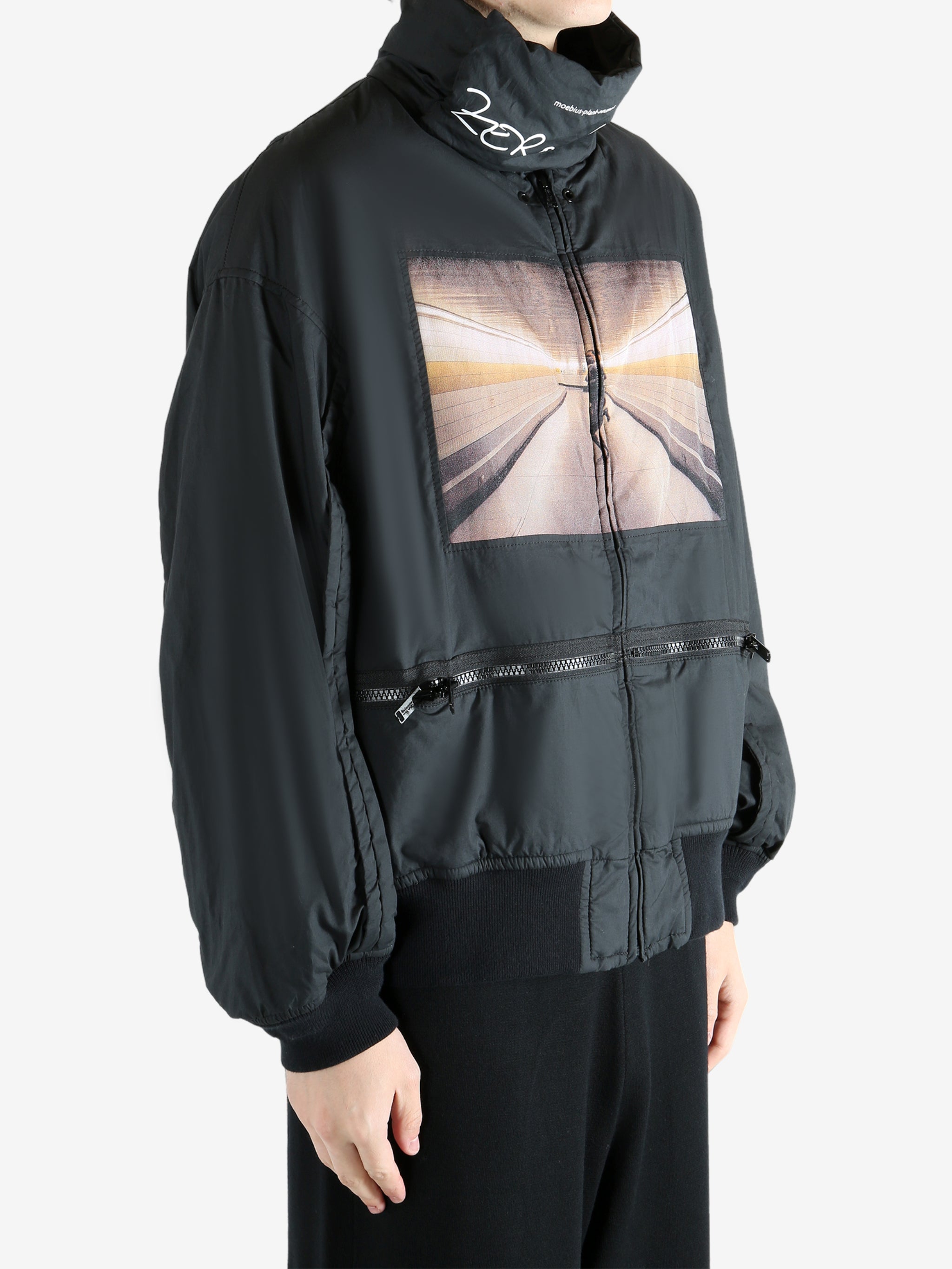 Black coat worn by a person, showing the coat's fit