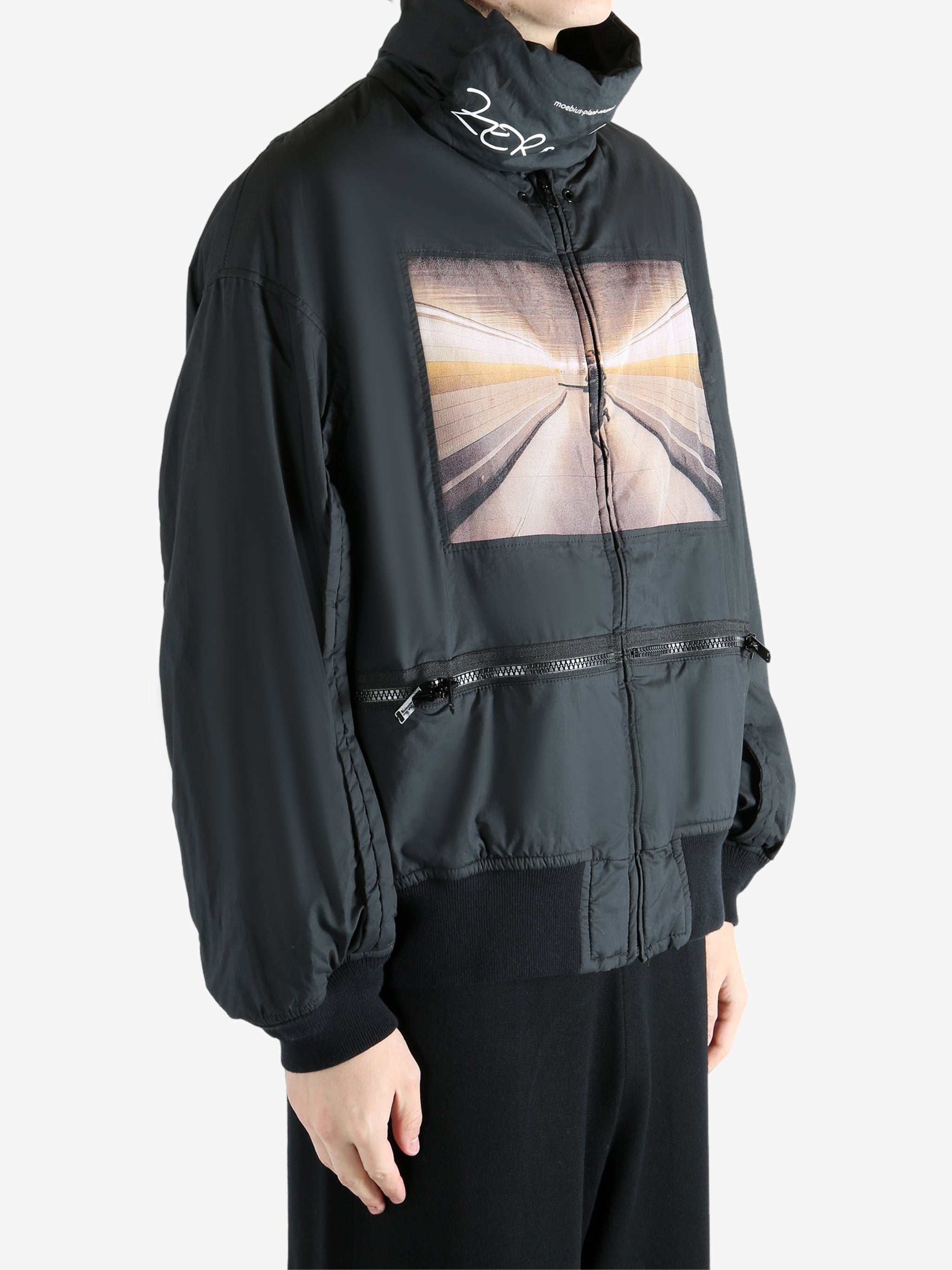 Black coat worn by a person, showing the coat's fit