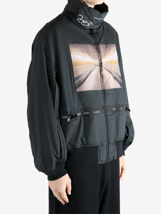 Black coat worn by a person, showing the coat's fit