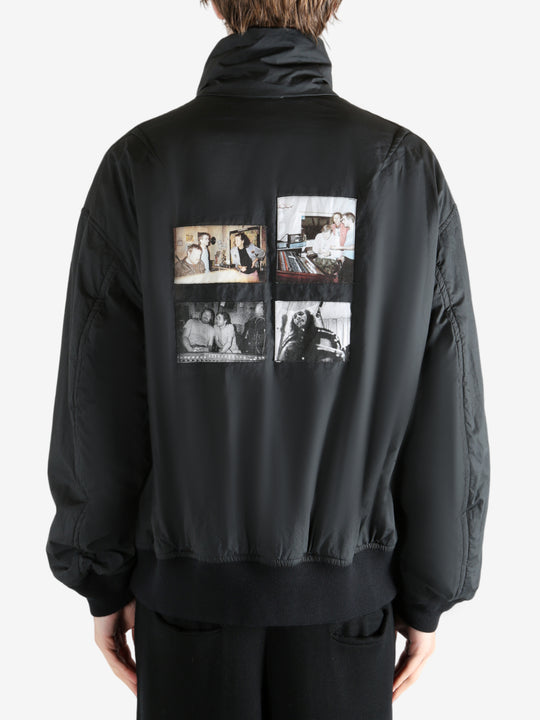 Black coat worn by a person, showing the coat's fit