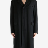 Black coat worn by a person, showing the coat's fit