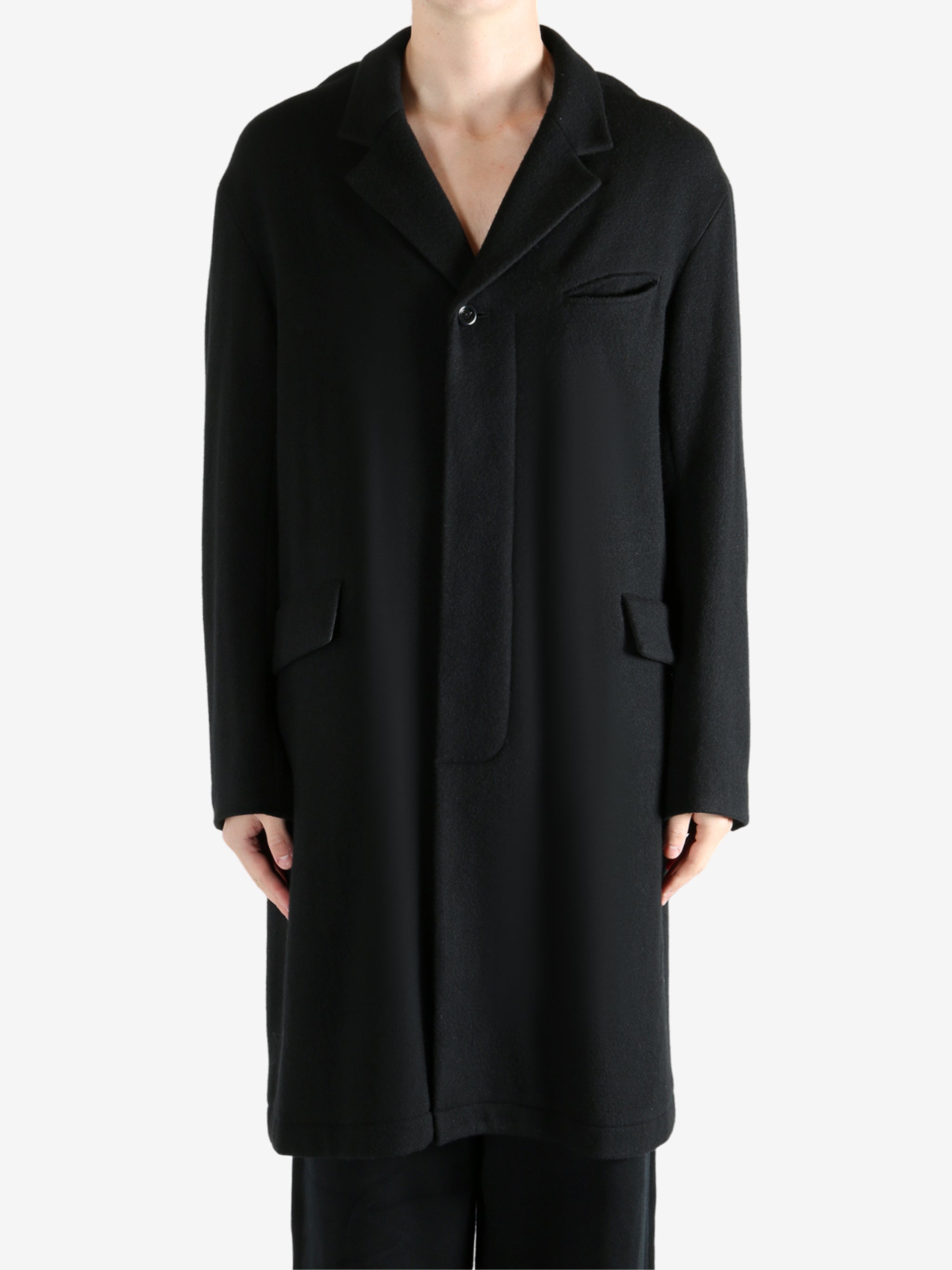 Black coat worn by a person, showing the coat's fit