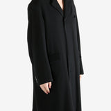 Black coat worn by a person, showing the coat's fit