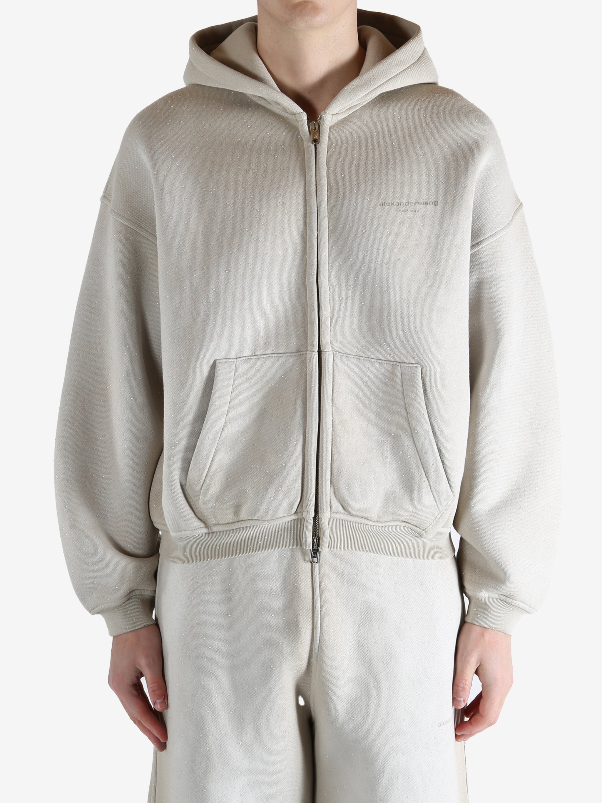 White hoodie worn by a person, showing the hoodie's fit