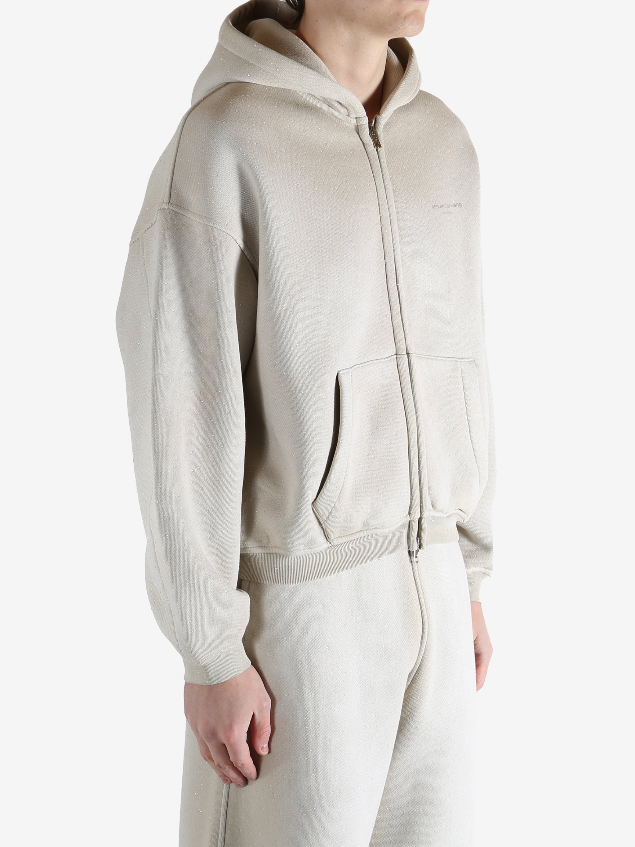 White hoodie worn by a person, showing the hoodie's fit