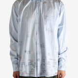 White shirt worn by a person, showing the shirt's fit