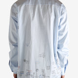 White shirt worn by a person, showing the shirt's fit