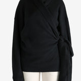 Black knitwear worn by a person, showing the knitwear's fit