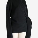 Black knitwear worn by a person, showing the knitwear's fit