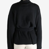 Black knitwear worn by a person, showing the knitwear's fit