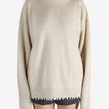 Tan knitwear worn by a person, showing the knitwear fit