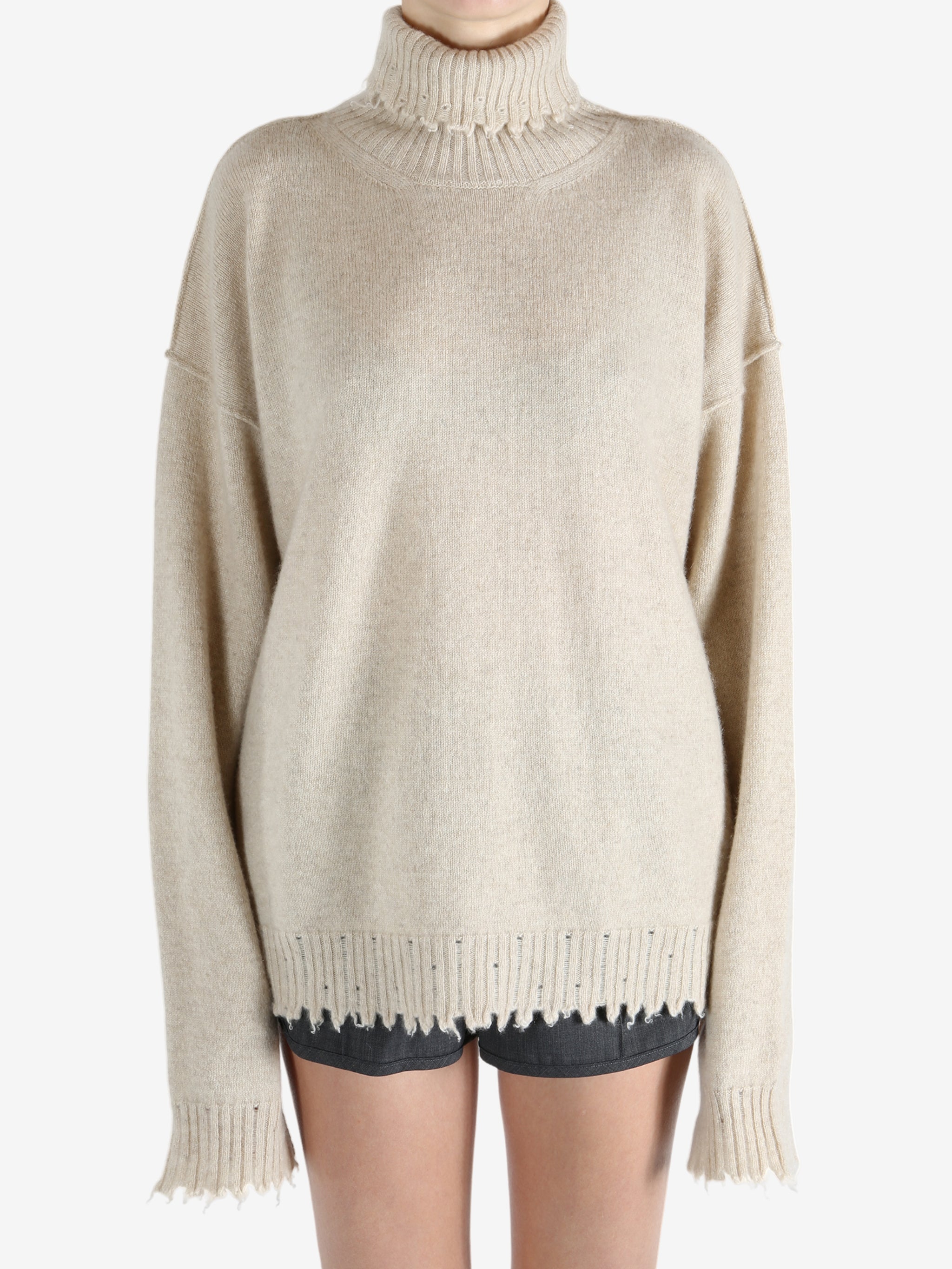 Tan knitwear worn by a person, showing the knitwear fit