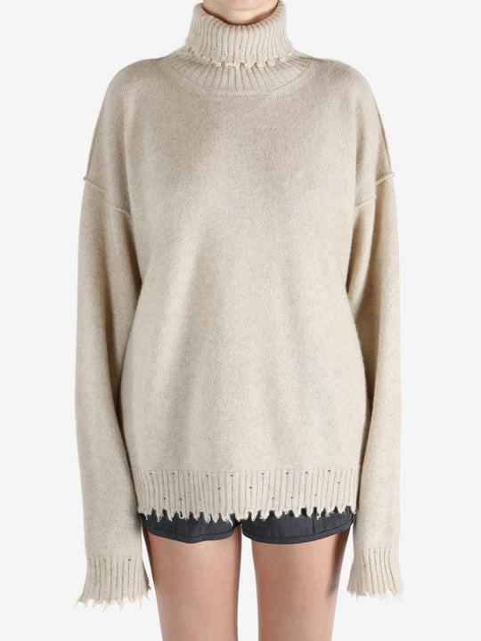 Tan knitwear worn by a person, showing the knitwear fit