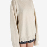 Tan knitwear worn by a person, showing the knitwear fit