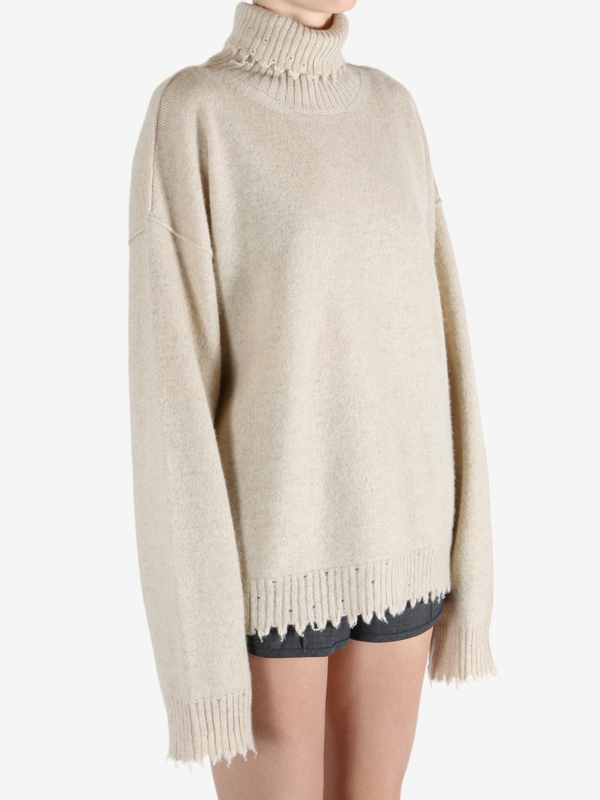 Tan knitwear worn by a person, showing the knitwear fit