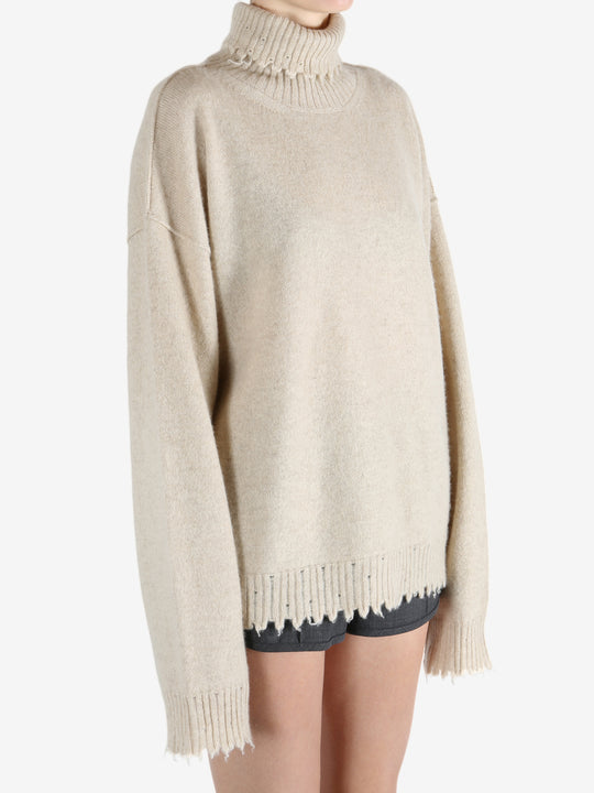 Tan knitwear worn by a person, showing the knitwear fit