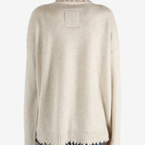 Tan knitwear worn by a person, showing the knitwear fit