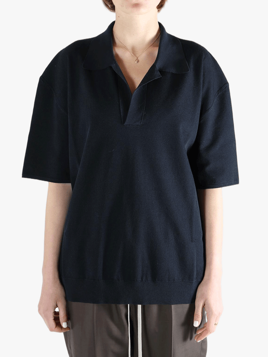 Black top  worn by a person, showing the top 's fit