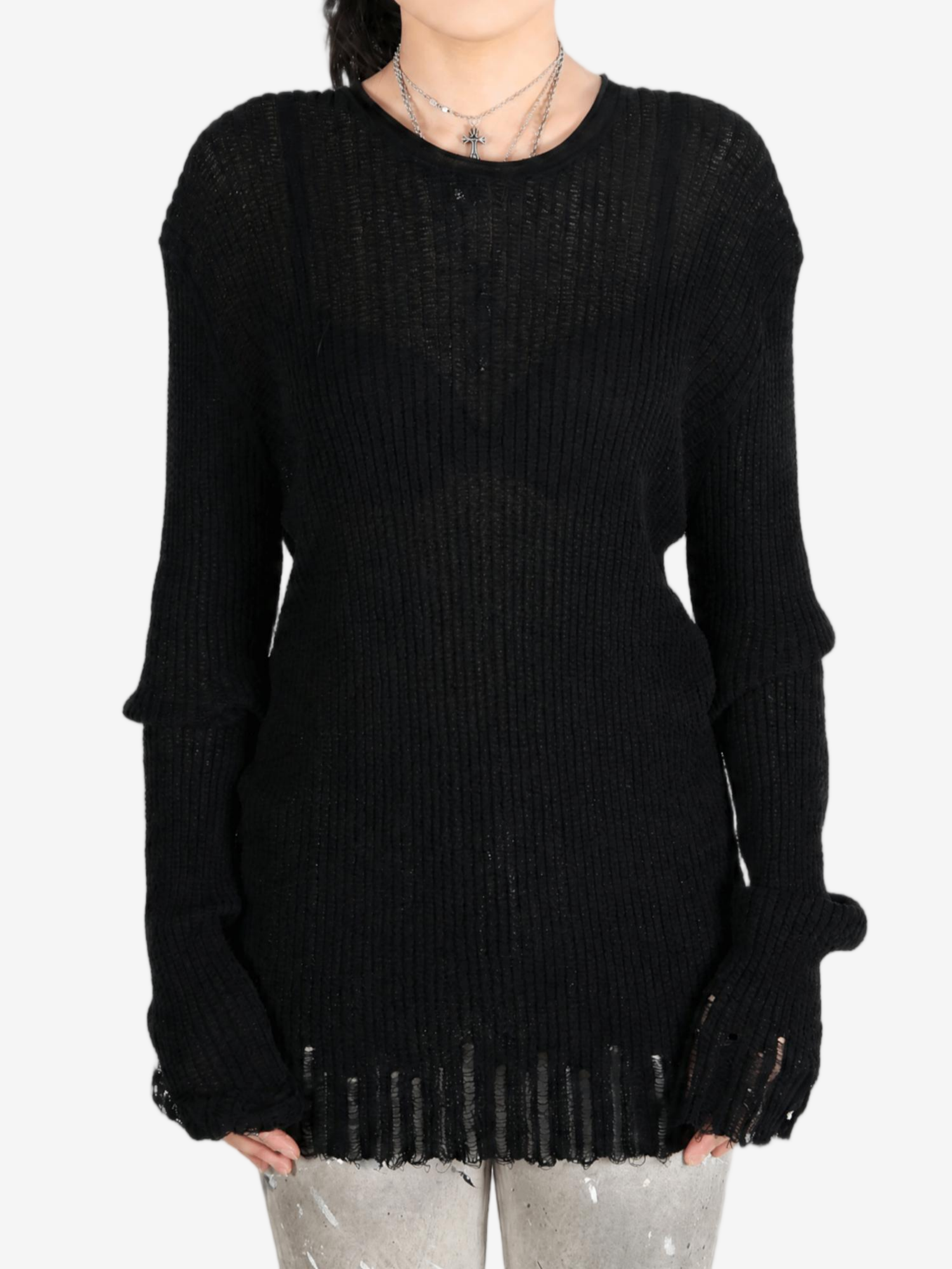 Black sweater worn by a person, showing the sweater's fit