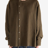 Brown knitwear worn by a person, showing the knitwear's fit