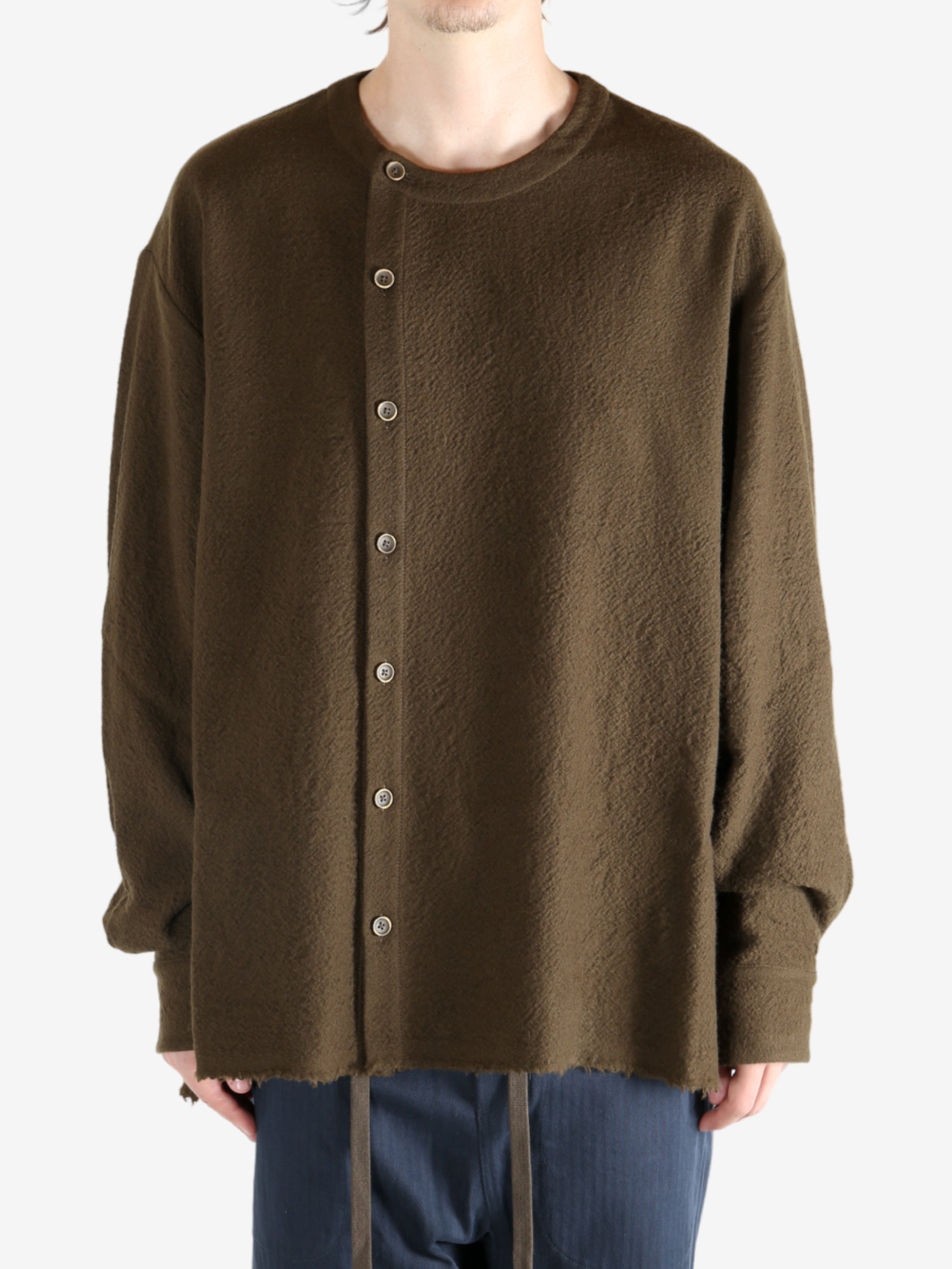 Brown knitwear worn by a person, showing the knitwear's fit