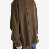 Brown knitwear worn by a person, showing the knitwear's fit