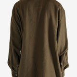 Brown knitwear worn by a person, showing the knitwear's fit