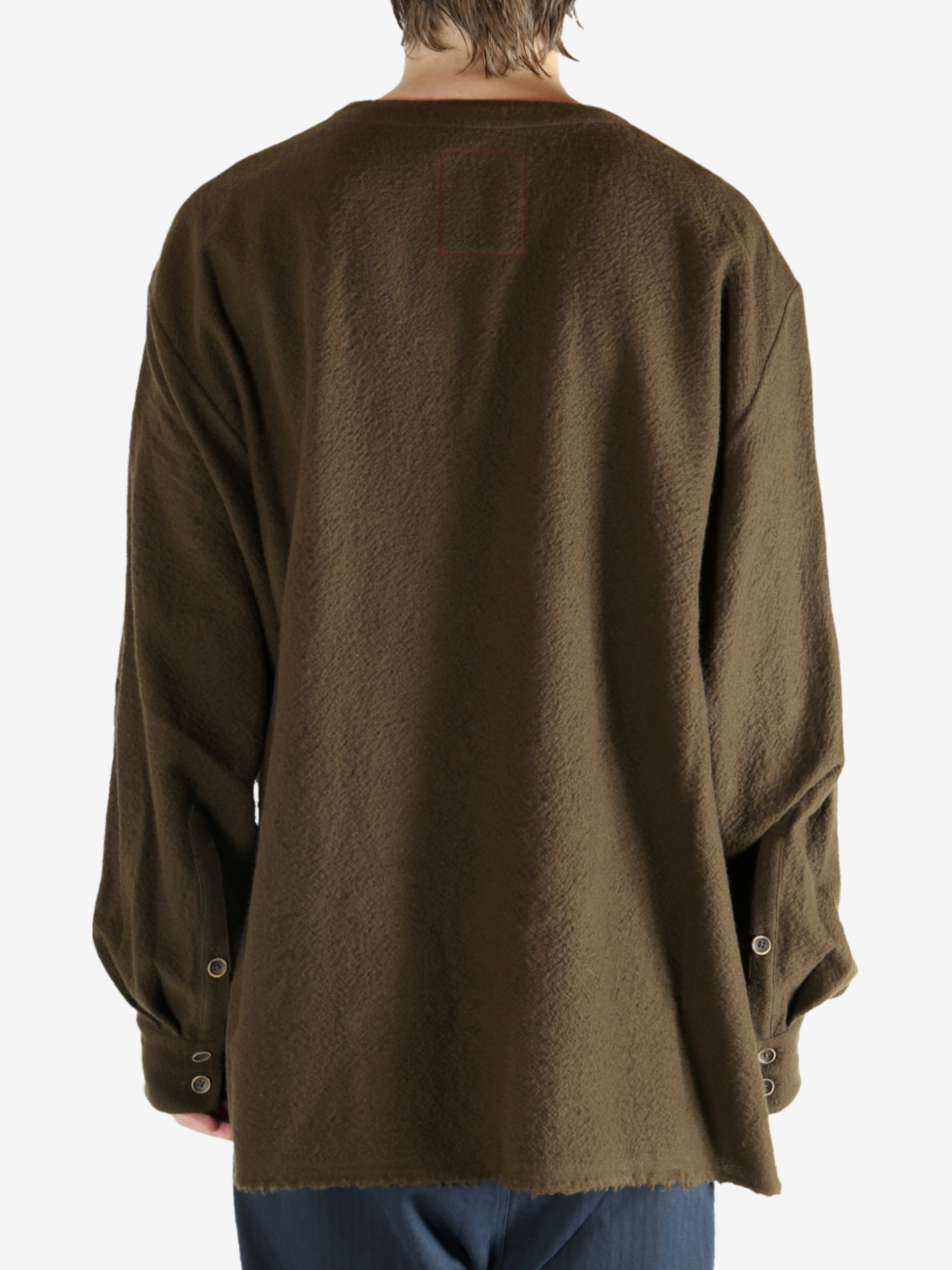 Brown knitwear worn by a person, showing the knitwear's fit