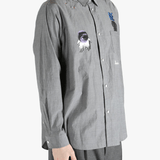 Grey shirt worn by a person, showing the shirt's fit
