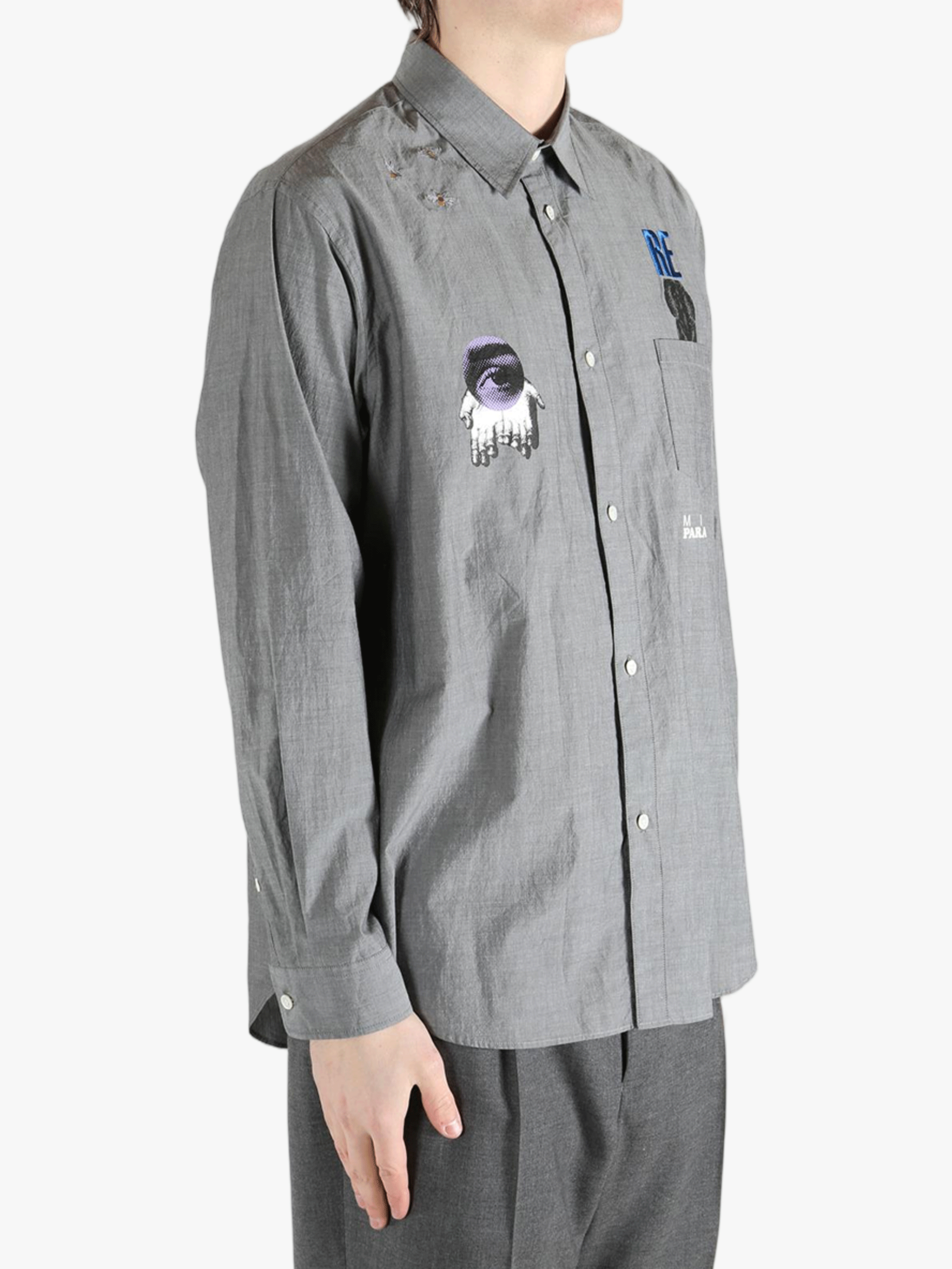 Grey shirt worn by a person, showing the shirt's fit