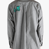 Grey shirt worn by a person, showing the shirt's fit