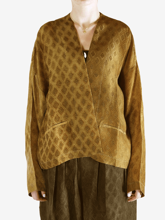 Yellow coat  worn by a person, showing the coat 's fit