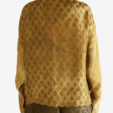 Yellow coat  worn by a person, showing the coat 's fit