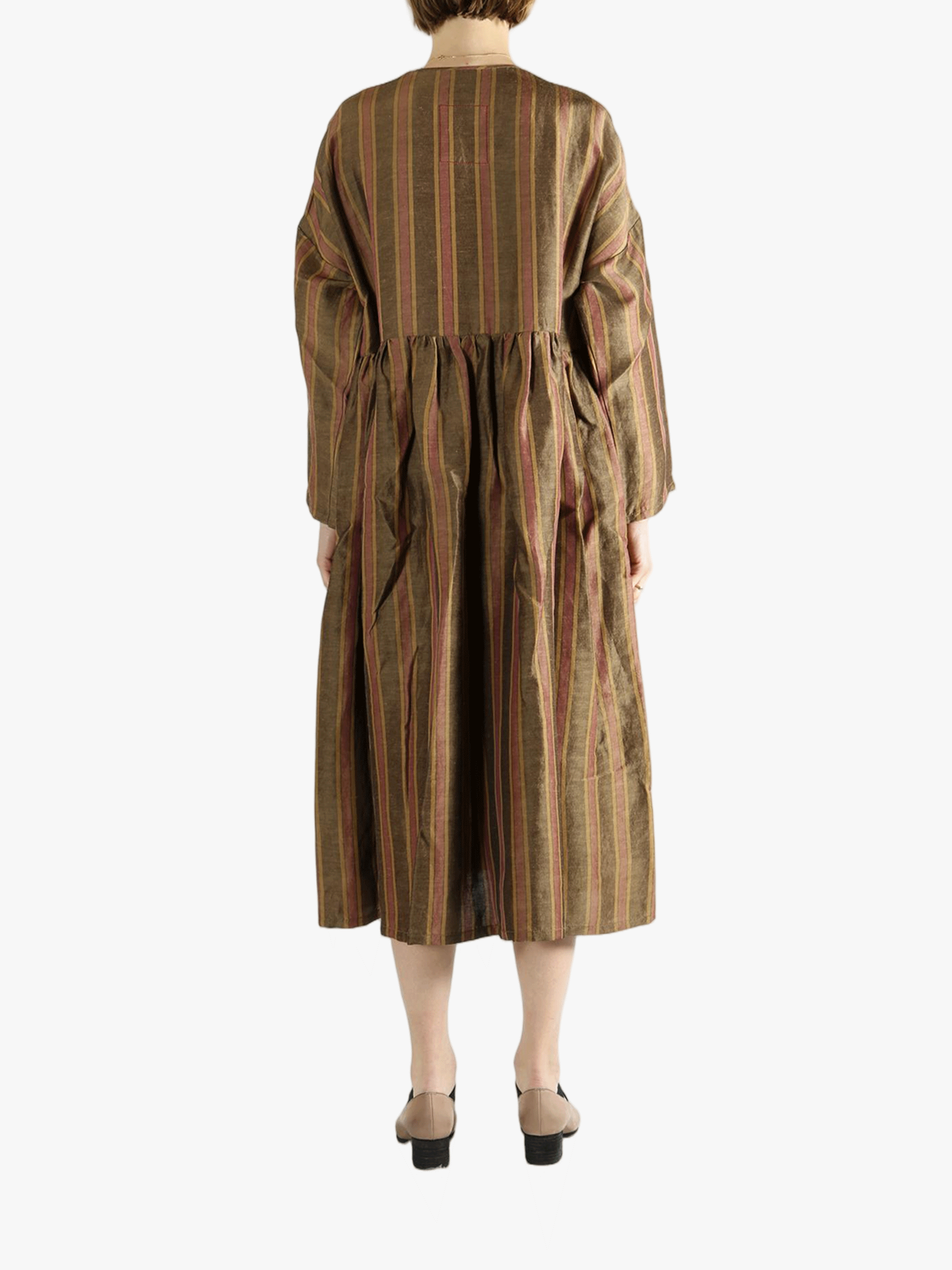 Brown coats worn by a person, showin the coats' fit