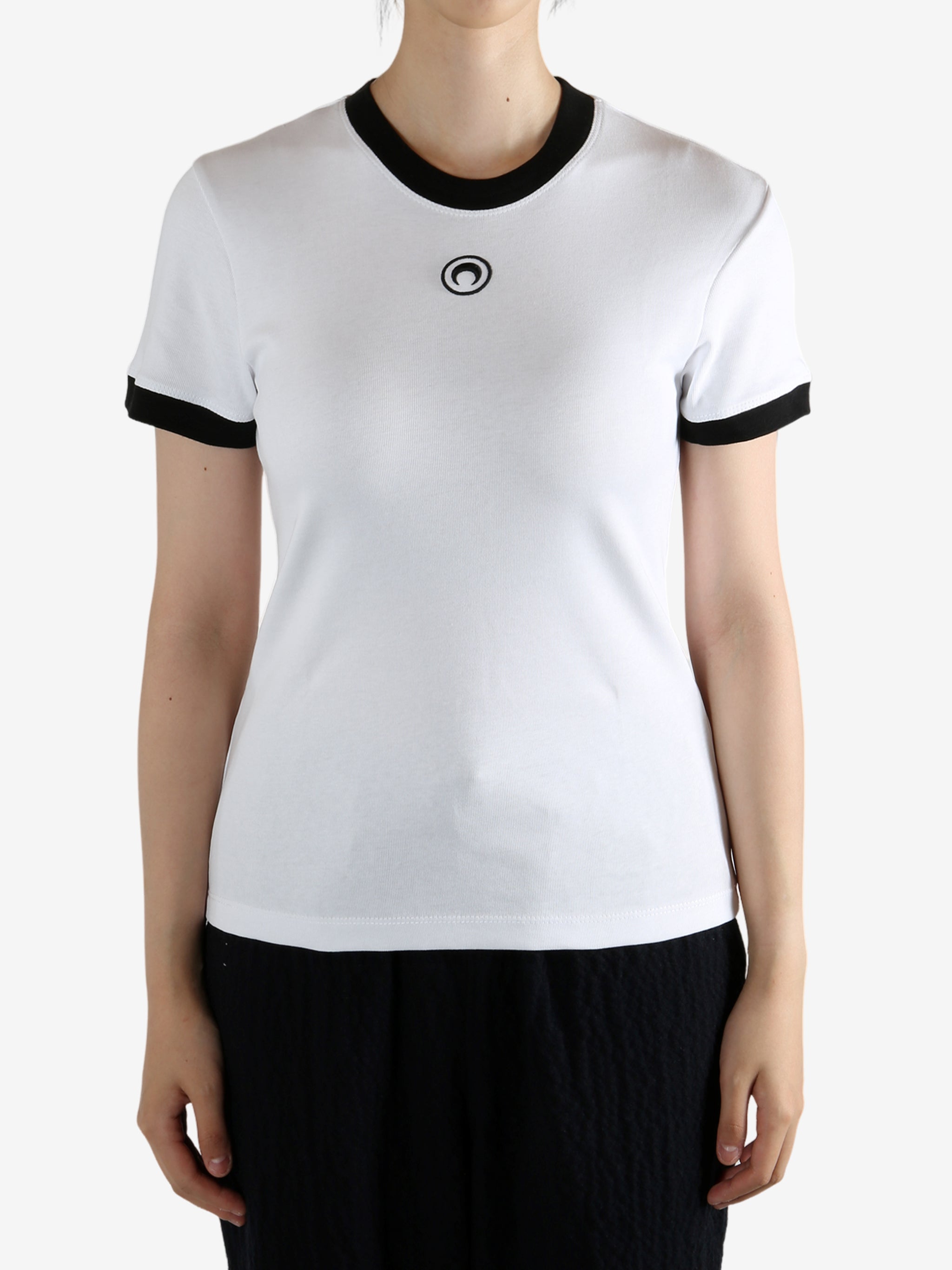 White t-shirt worn by a person, showing the shirt's fit